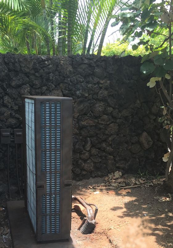 Thompson Art Studios faux paint just about any interior or exterior surface to blend into its surroundings such as this AC unit painted to look like the surrounding lava rock wall on Hawaii's Kohala Coast. 