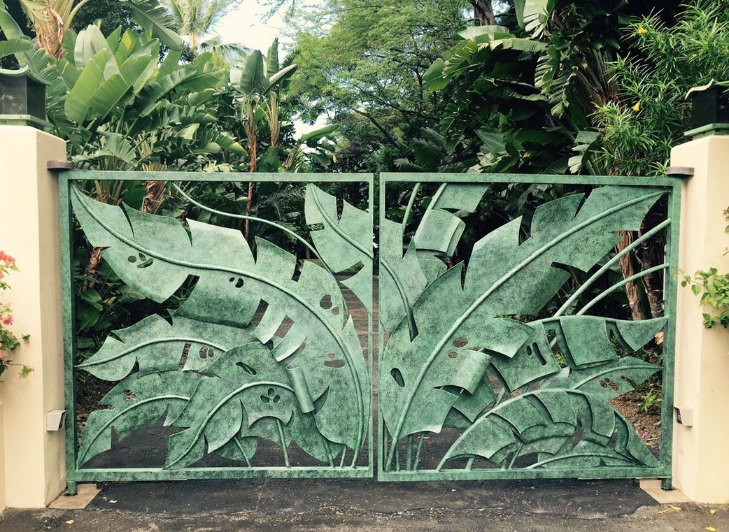 Faux paint by Thompson Art Studios on entry gates make a remarkable enhancement to any entry such as this faux verdigris leaf gate. 