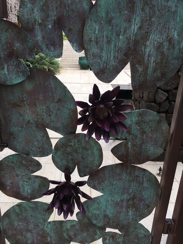 Thompson Art Studios applies faux copper verdigris finish to exterior metal gate.