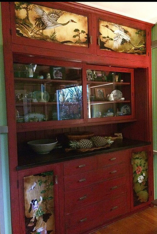 Thompson Art Studios finished this cabinet with a vibrant red and designed hand-painted  Asian inspired panels with gold leaf accents for a North Kohala, Hawaii home. 