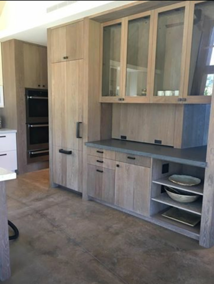 Thompson Art Studio masterfully create the look and feel of natural driftwood on these cabinets in a home in Hawaii with a fine cersuse finish and WOCA oil. 